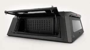 Black MOLLE storage panel inside an aluminum pickup truck canopy