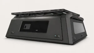 Black roof rack mounted on an aluminum pickup truck canopy