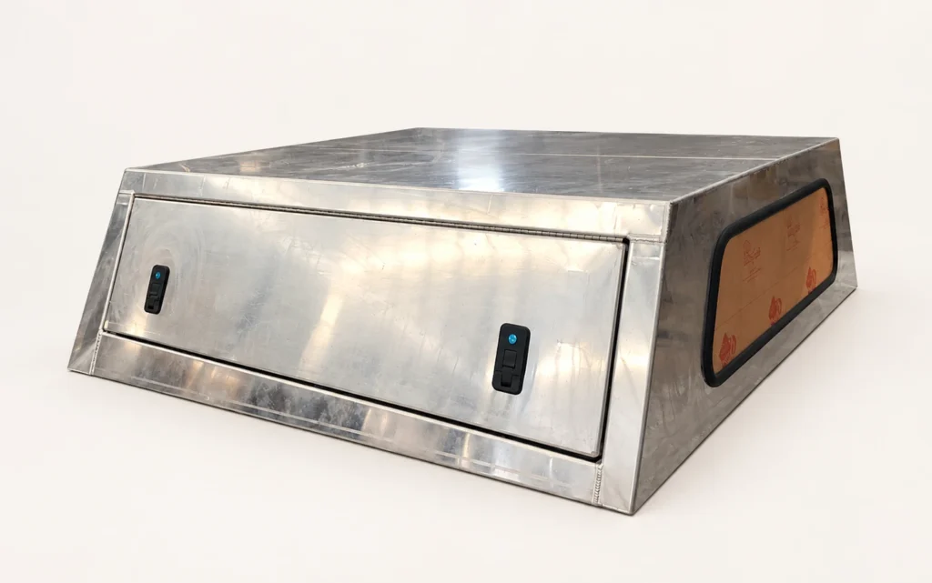 Unfinished aluminum pickup canopy with a solid side door and two black latches
