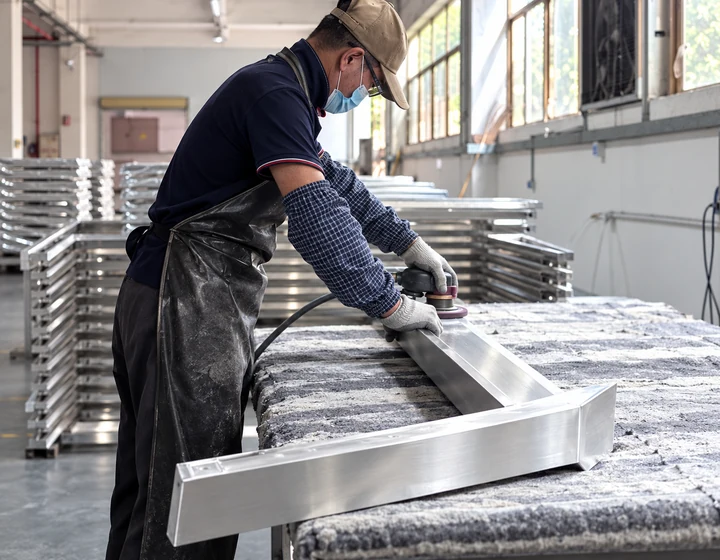 Technician grinding and polishing fabricated aluminum components